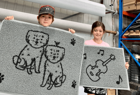two young entrepreneurs with Les Petits Tapis creations.
